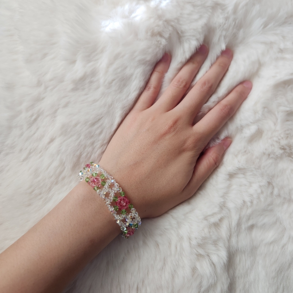 Handmade pink green and white beaded flower bracelet with silver heart detail